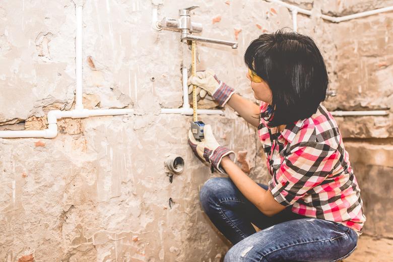 Woman using  tape measure.