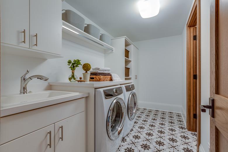 Patterned tile flooring in big laundry room.