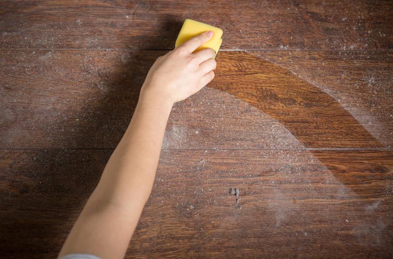 Using sponge for cleaning dusty wood