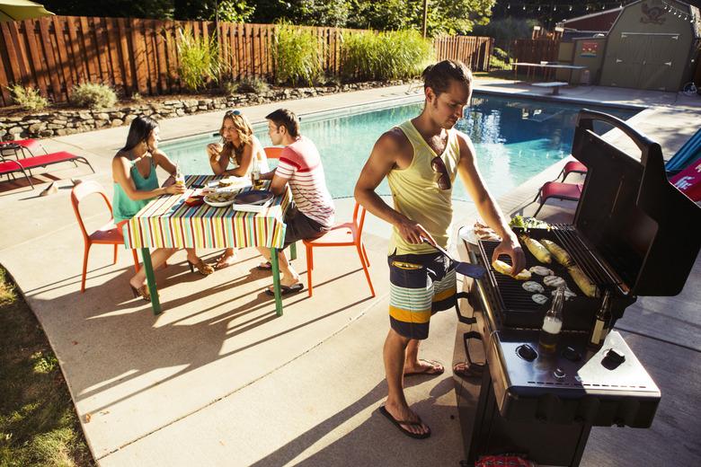 Friends enjoying a poolside meal.