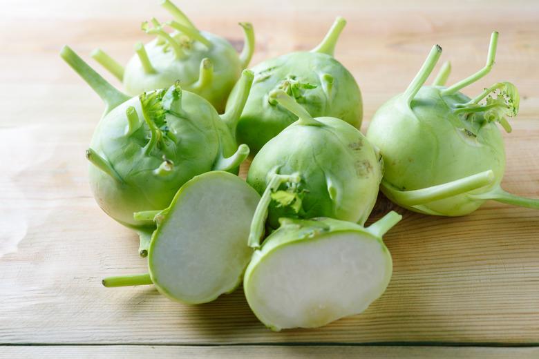 Fresh green kohlrabi or german turnip or turnip cabbage on wood background.