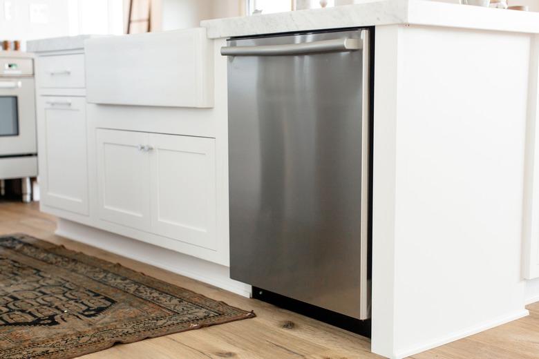 diswasher installed in a white kitchen island