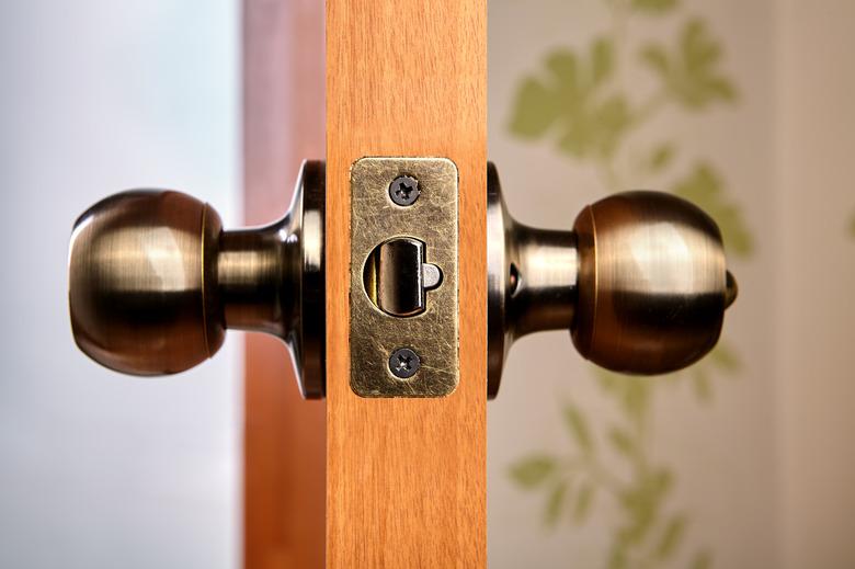 Door handles with latch, ball-shaped, bronze color.