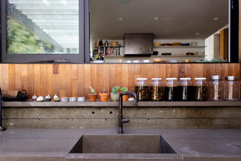 wood backsplash above concrete sink