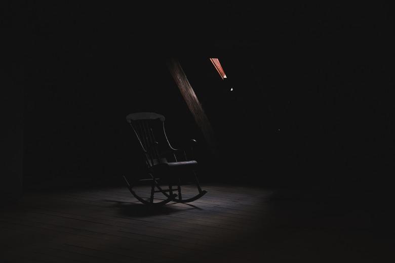 Rocking chair in a dark space.