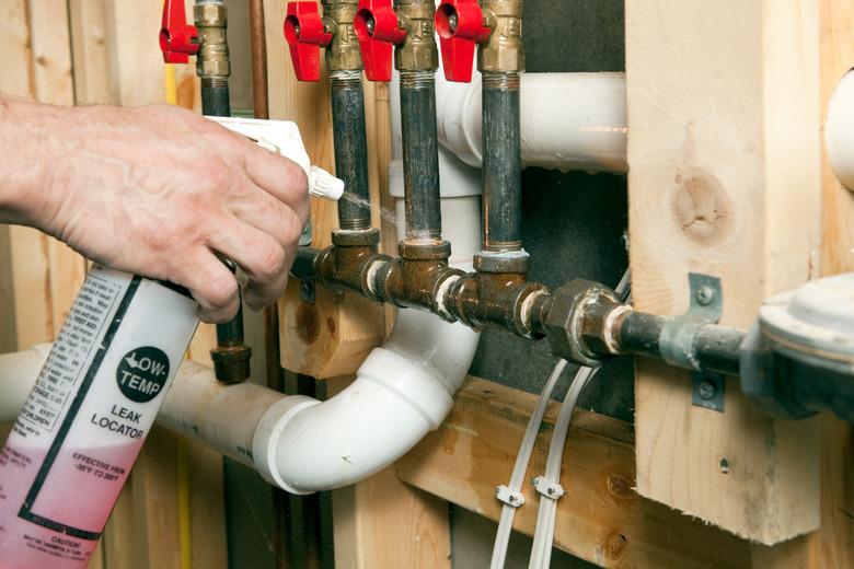 Plumber Using Leak Locator Spray on Gas Lines