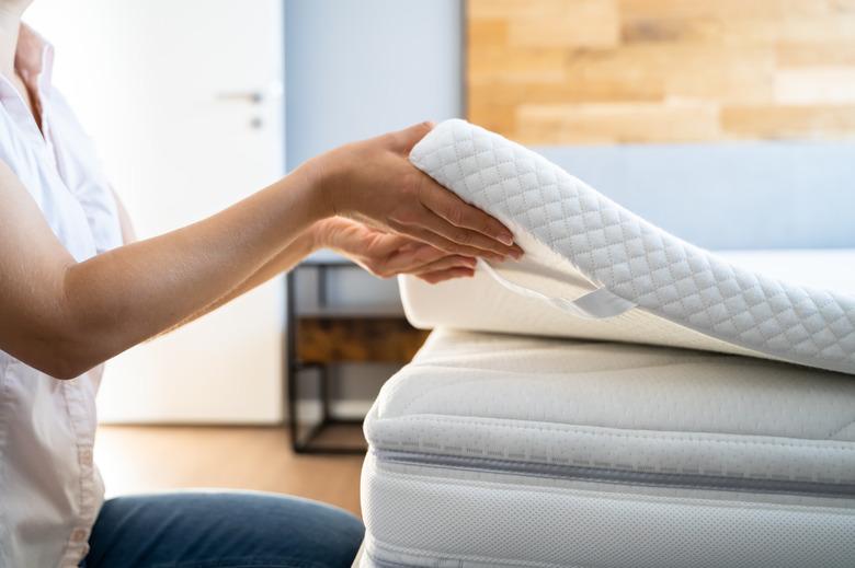 Mattress Topper Being Laid On Top