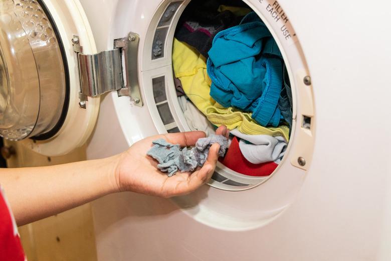 Handful of lint trapped in filter of laundry dryer machine