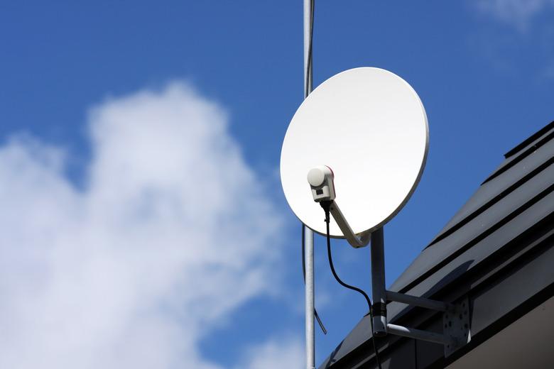 Close-up of a white satellite receiver dish on the roof