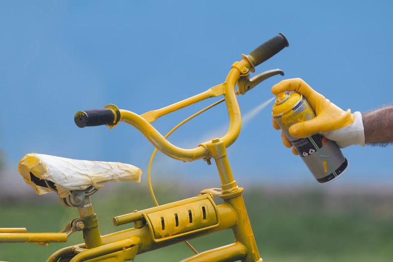 Photo of yellow bike painting with yellow glove