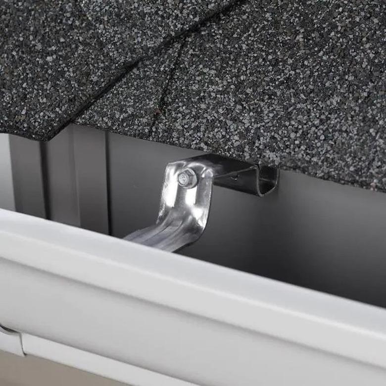 A hidden gutter hanger is attached to a roof