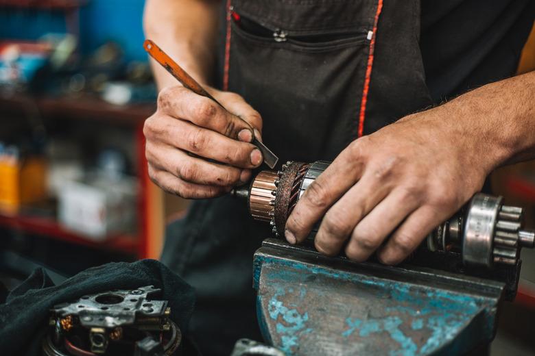 Manual worker repairing electric motor in a workshop