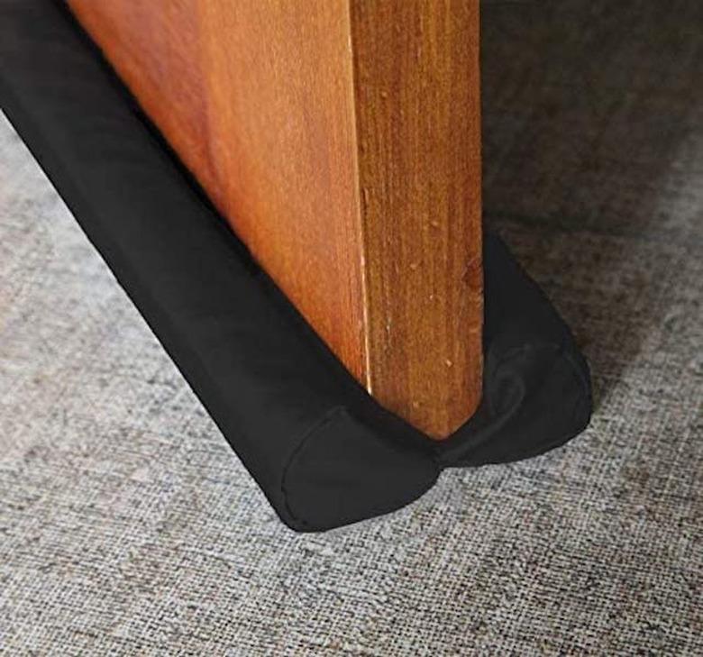 A black door sweep on a wooden door