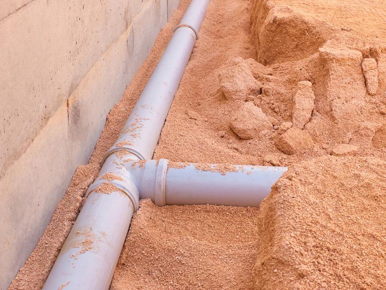 Junction of plastic sewer pipes. Sewage pipeline system of residential building under construction