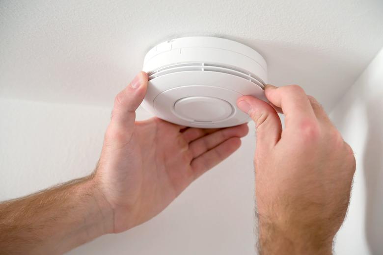 Man installing smoke detector