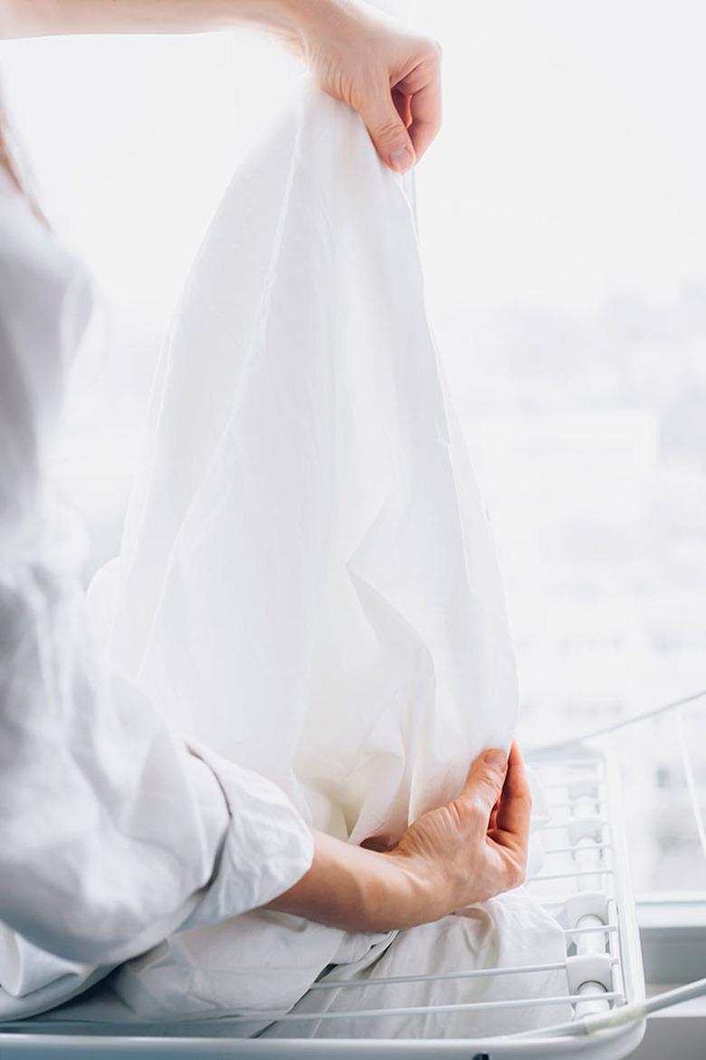 Hanging sheets on clothesline