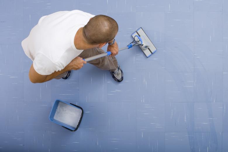 High angle view of man mopping floor