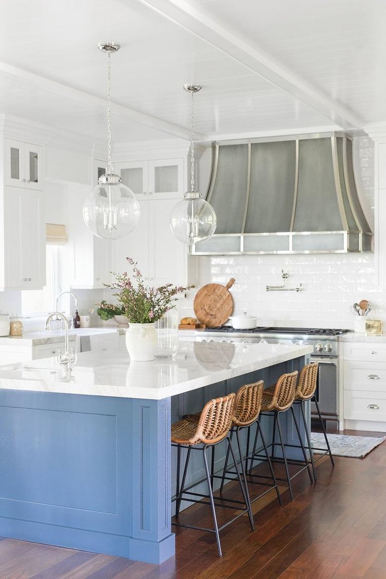 blue and white kitchen trend in 2019 with large island and white subway tile backsplash