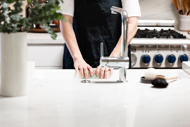 woman standing by kitchen sink