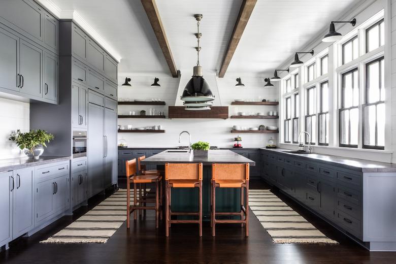 industrial kitchen with navy blue cabinets and wood shelving