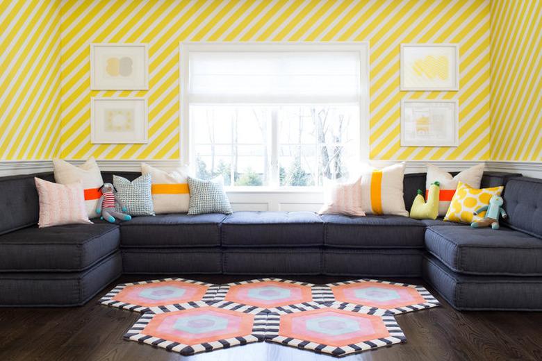 living room wallpaper idea with graphic yellow stripe installed diagonally