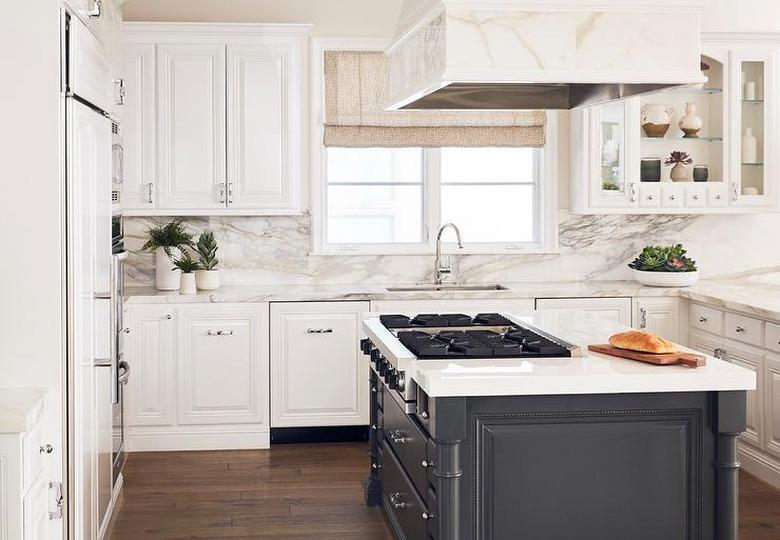 Traditional kitchen design with an island stovetop designed by Alexis Manfer Interior Design.