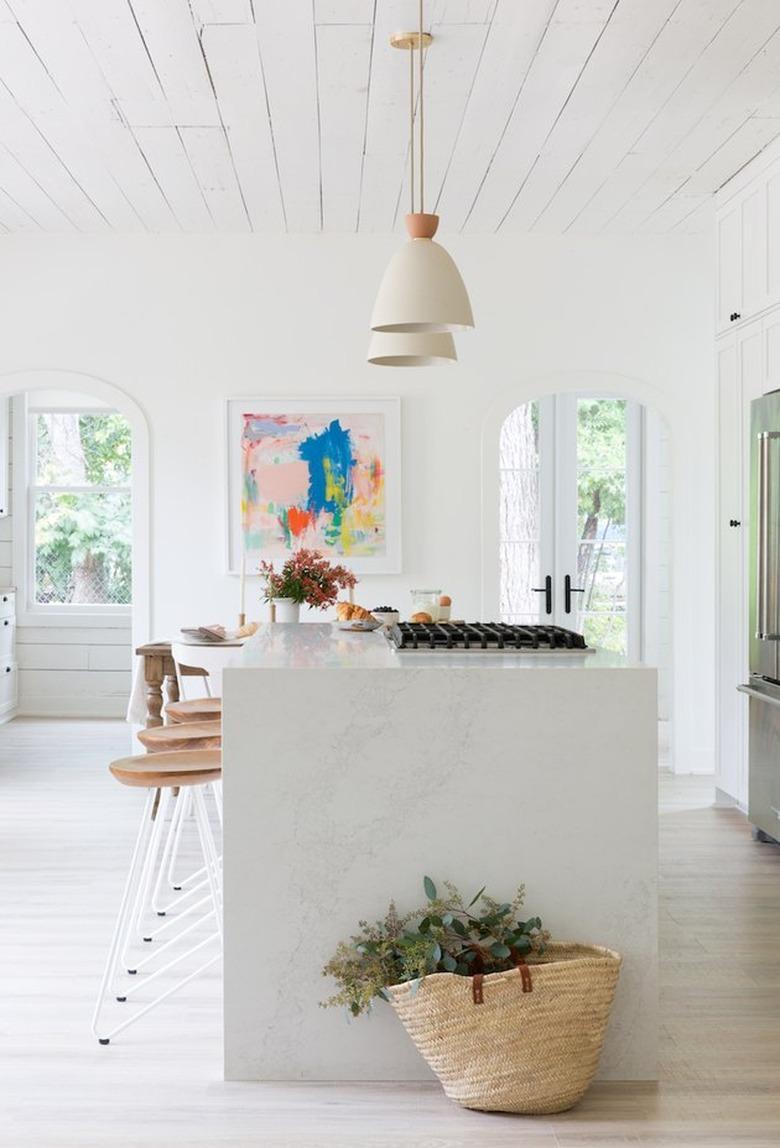 Modern kitchen design with an island stovetop by Camille Styles.