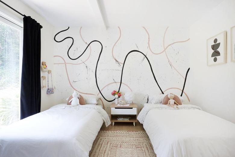 Kids' minimalist bedroom with modern mural and white bedding