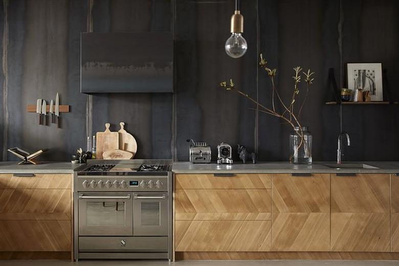 industrial design with stainless steel kitchen appliances and wood cabinets