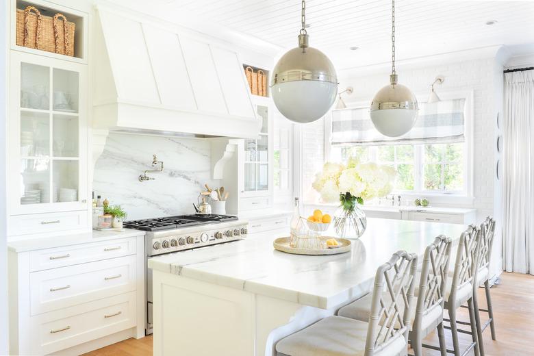 white kitchen cabinet color with marble countertops and island