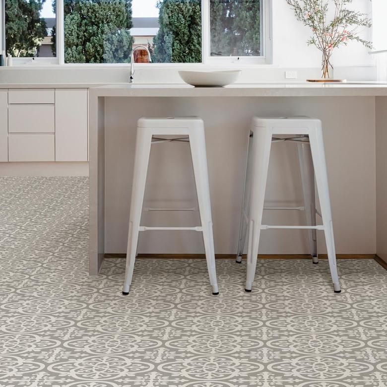 kitchen space with white stools and patterned flooring