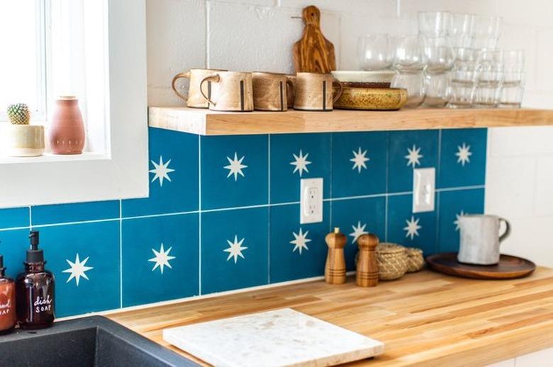 kitchen idea with wood countertops and open shelving with blue backsplash