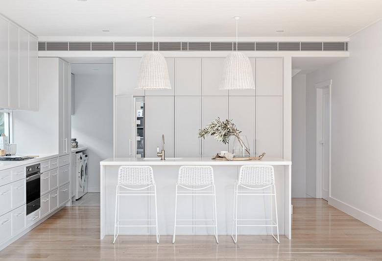 contemporary white kitchen island ideas with seating and white bar chairs