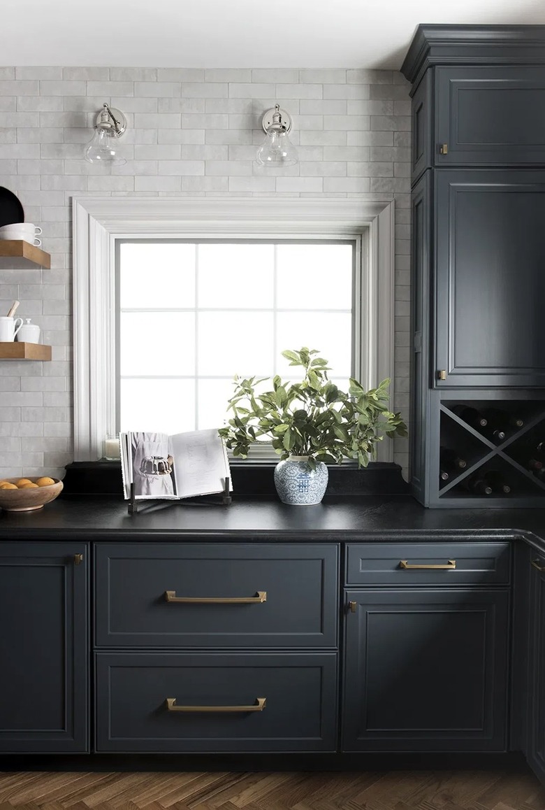 clear glass shade wall sconces in gray and dark blue kitchen