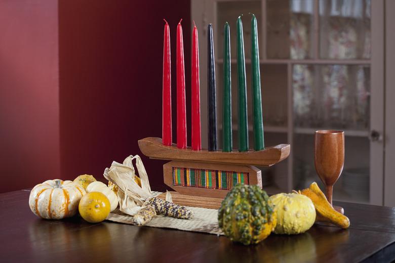 Kwanzaa decorations, alter with Kinara, corn, gourds, chalis