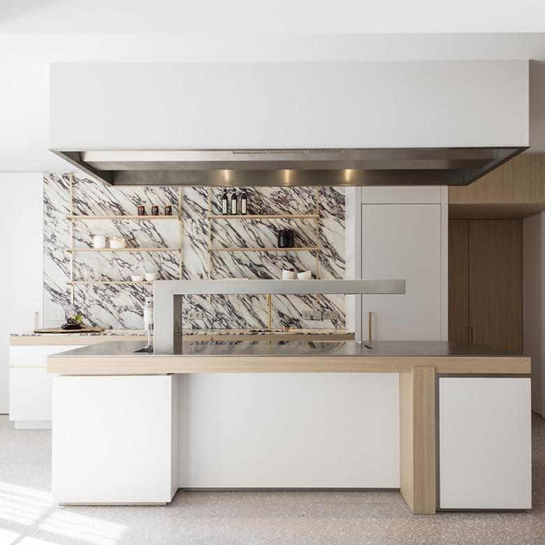 large kitchen with marble countertop and backsplash and open shelving