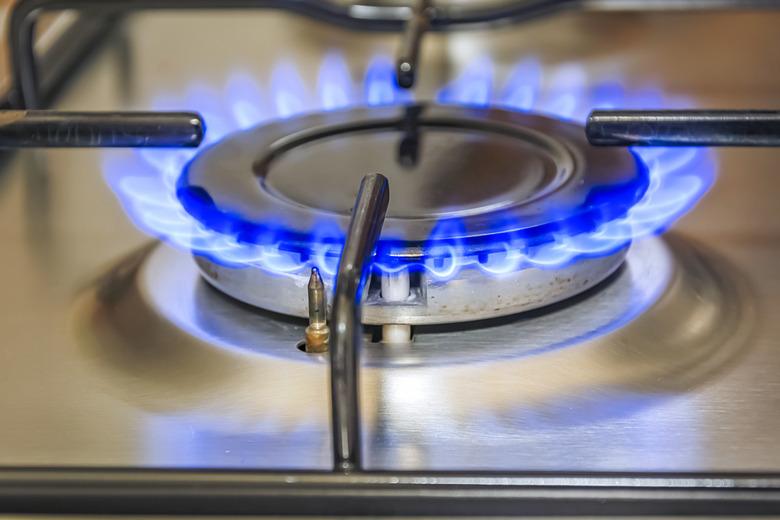 Close-up view of a kitchen cooker with blue flame