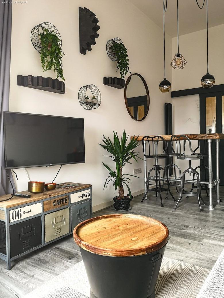 Industrial living room style with lofty ceiling and cage pendant lights