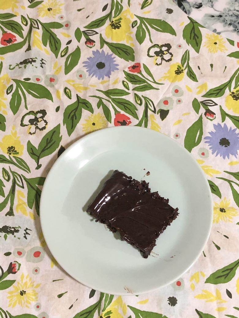 patterned tea towel with plate with chocolate cake on top