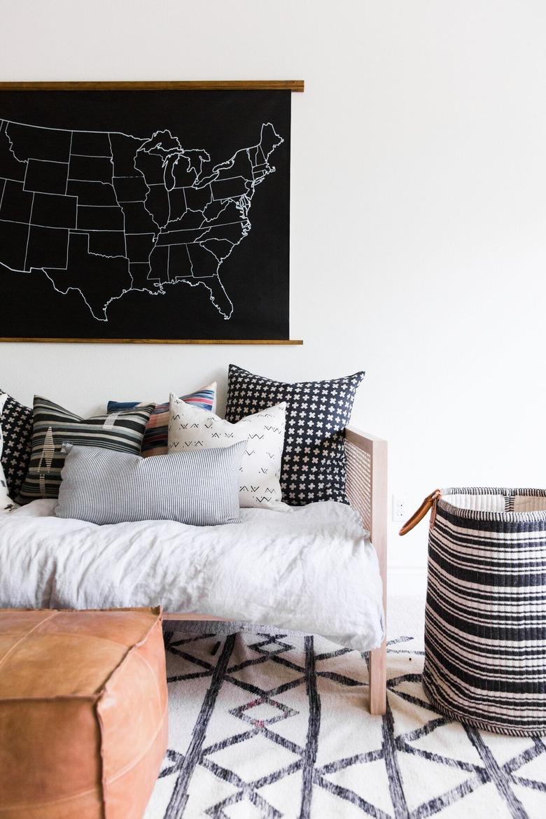 masculine boho decor in white room with sofa and pillows