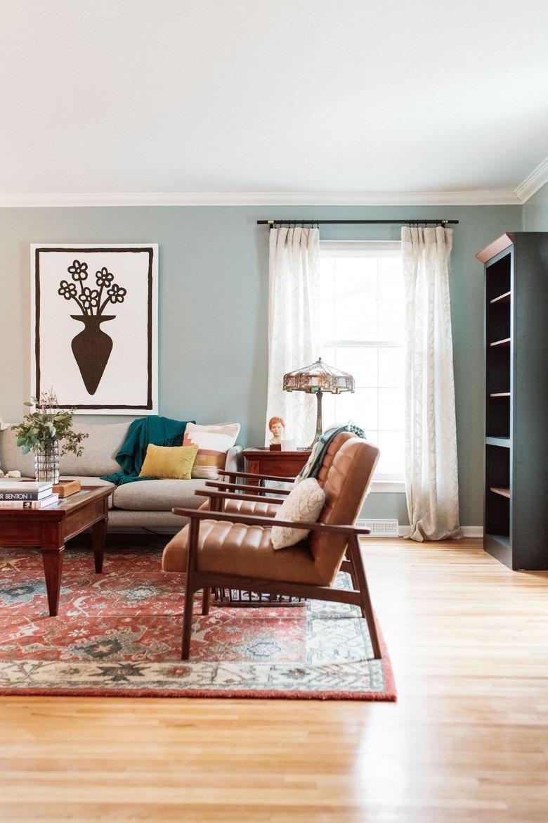 midcentury living room with wood and leather chairs