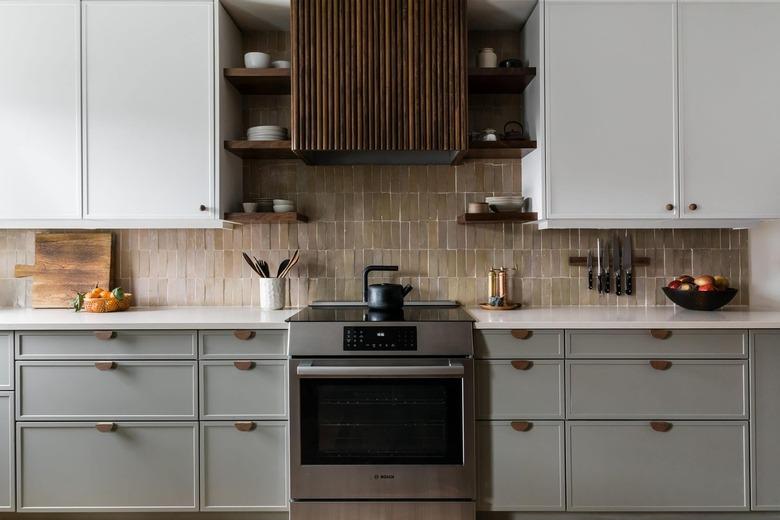 kitchen with gray lower cabinets and white uppers