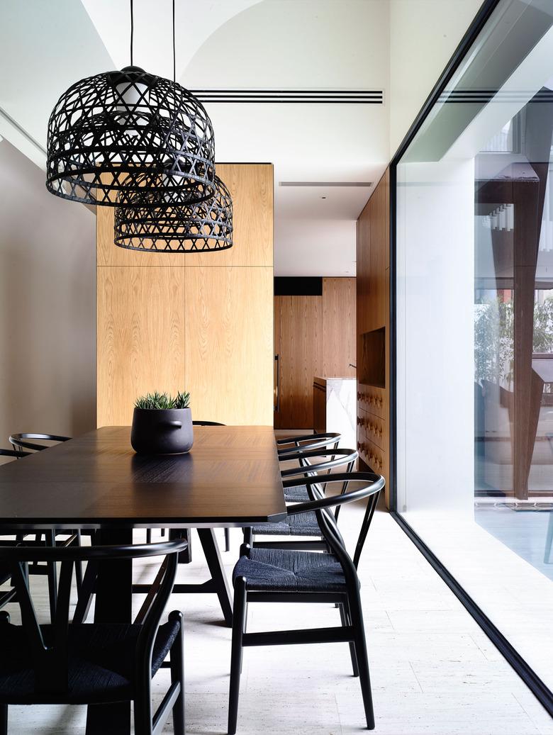 minimalist dining room idea with black furniture and lighting