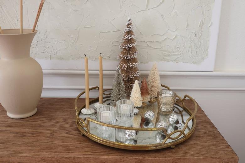 DIY mirrored tray centerpiece with glitter bottle brush trees and mercury glass