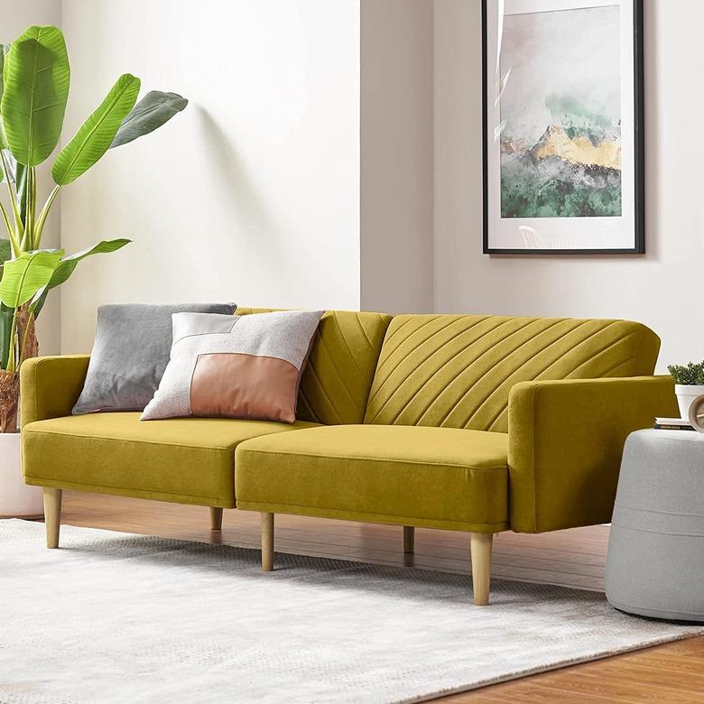 chartreuse velvet sofa in white-walled living room