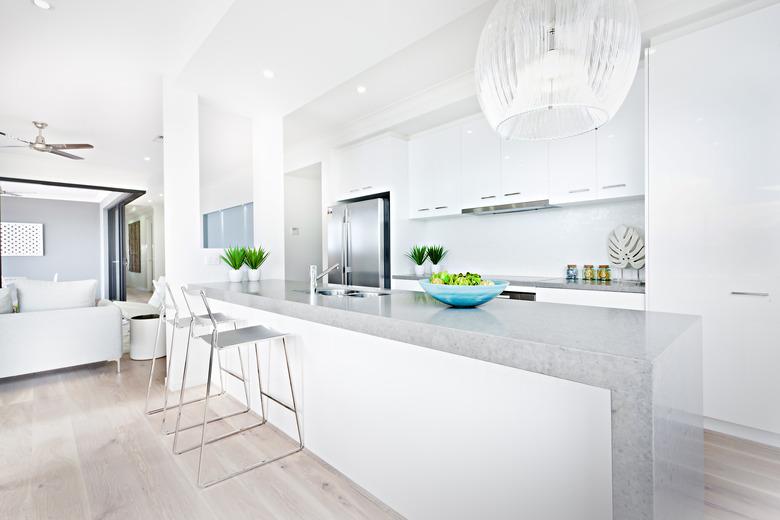 Luxury kitchen chairs and hanging lights with white walls