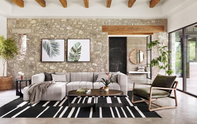 living room with big sectional and black and white rug