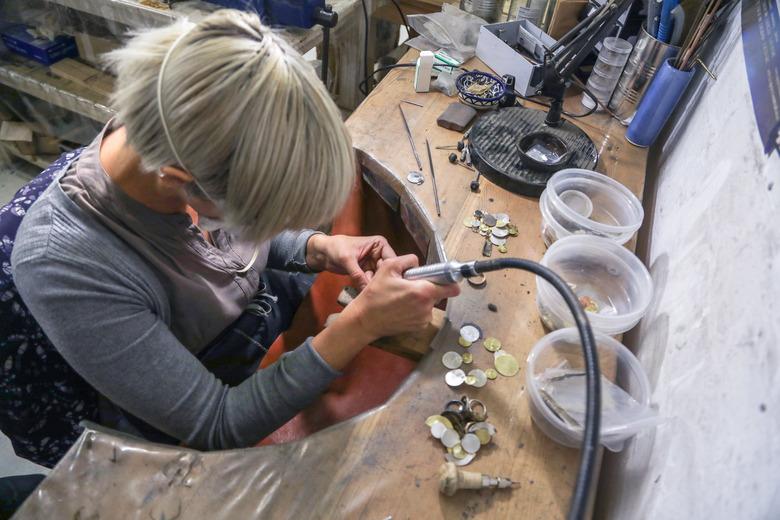 A jewelry designer working in her studio.