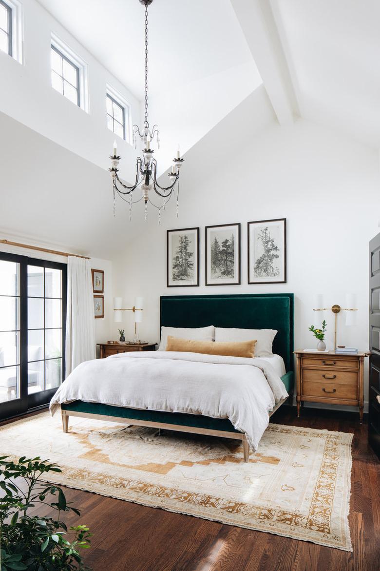 Traditional bedroom with chandelier and vintage rug