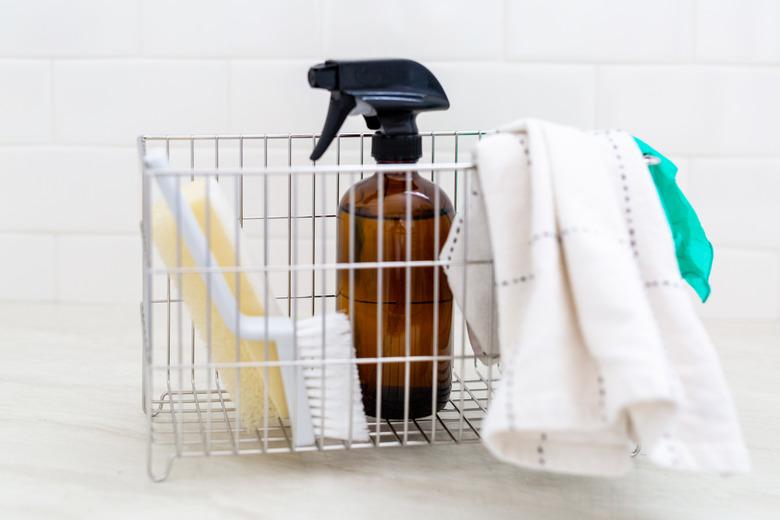 Cleaning bottle and cleaning supplies in wire basket